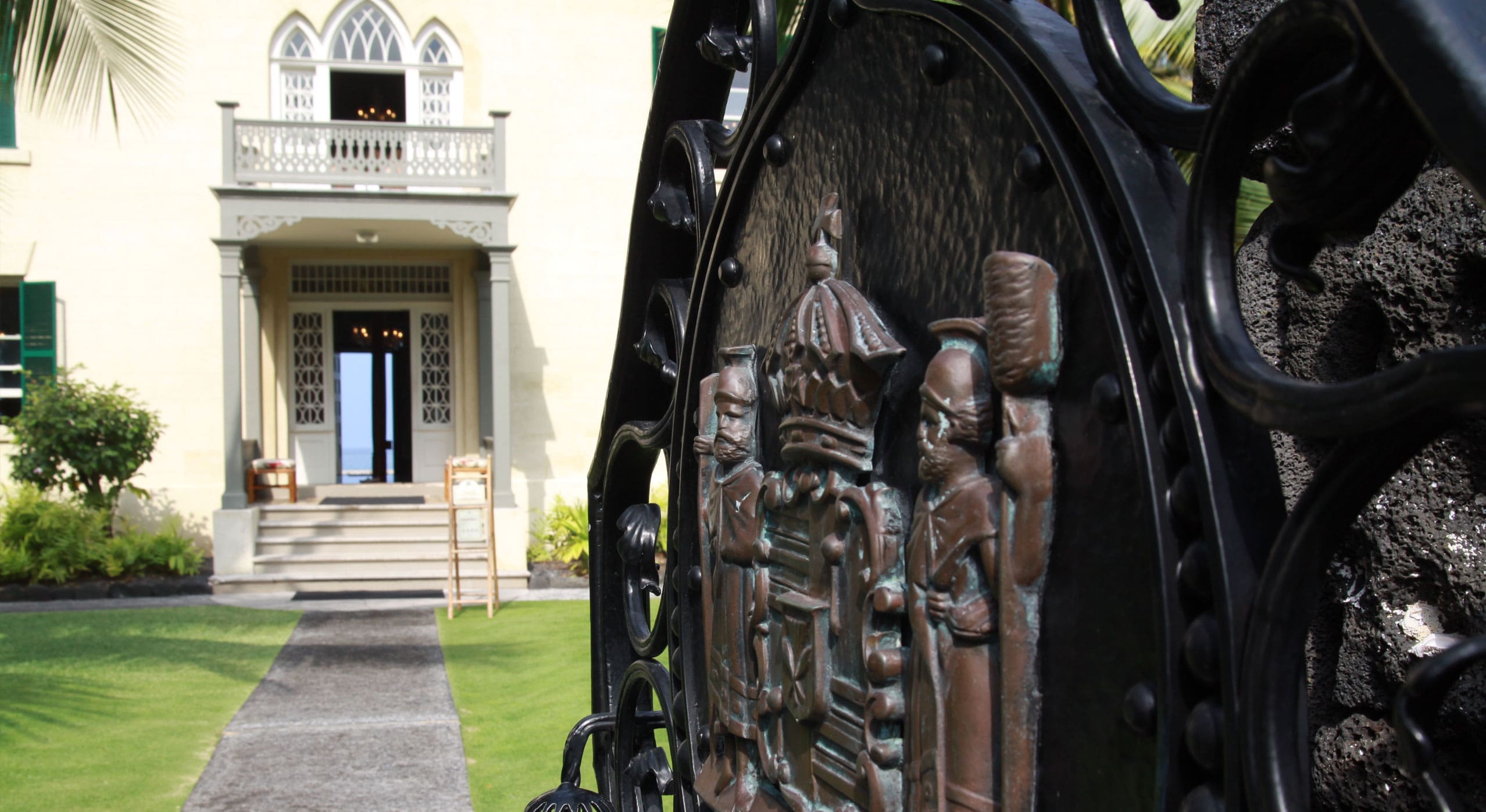 The ornate front gate holds the Hawaiian seal and leads to the graceful entry.