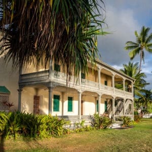 Warm afternoon sun highlights the elegant railings on two levels of ocean-facing lanais.